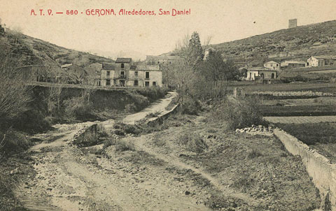 Vista de la vall de Sant Daniel. Al centre, entre els arbres, el monestir de Sant Daniel. Al fons a la dreta, la muntanya de Montjuïc i la torre Suchet. 1905-1911