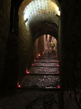 Carrer de Sant Llorenç, il·luminat amb espelmes que indiquen el camí per visitar la peça Aigües projectada al micvé