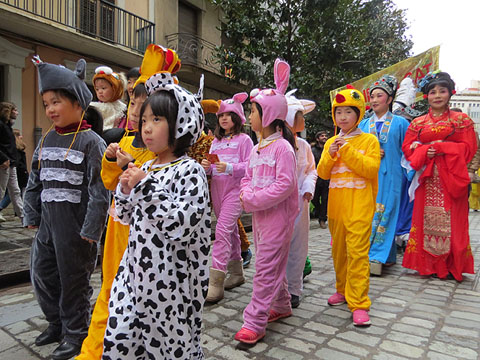 Mainada disfressada dels animals del calendari xin&egrave;s durant la cercavila