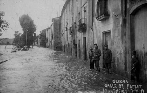 Vista del carrer Pedret inundat pel desbordament del riu Ter. Al fons sobresurt l'esgl&eacute;sia del Pilar. 1919
