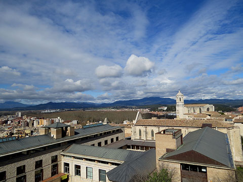 Vista dels teulats de Girona des del tram de muralla. En primer terme, les dependències universitàries del campus del Barri Vell